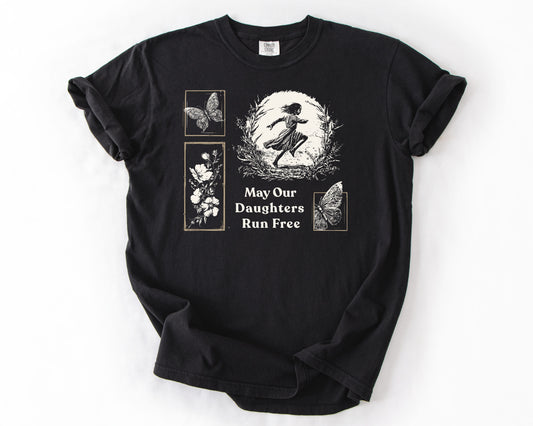 Black t-shirt with May Our Daughters Run Free botanical illustration – human rights shirt