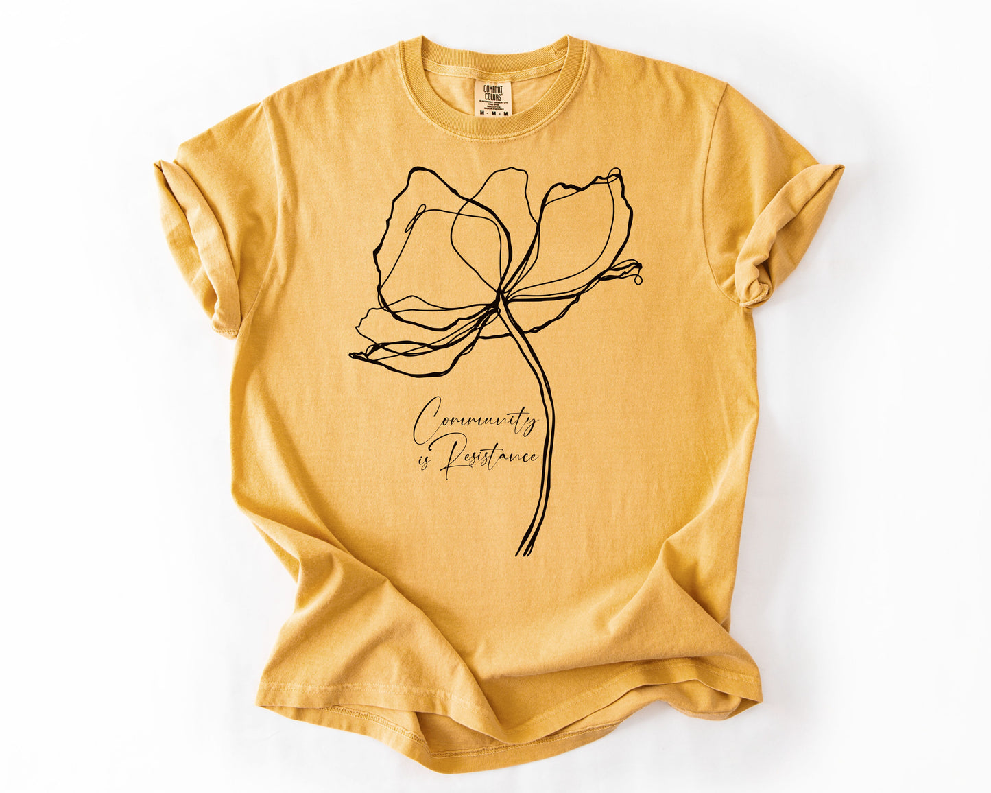 Mustard t-shirt with Community Is Resistance botanical graphic – resistance shirt