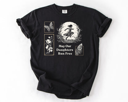 Black t-shirt with May Our Daughters Run Free botanical illustration – human rights shirt